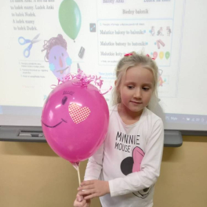 pokaż obrazek - Uczennica trzyma balon